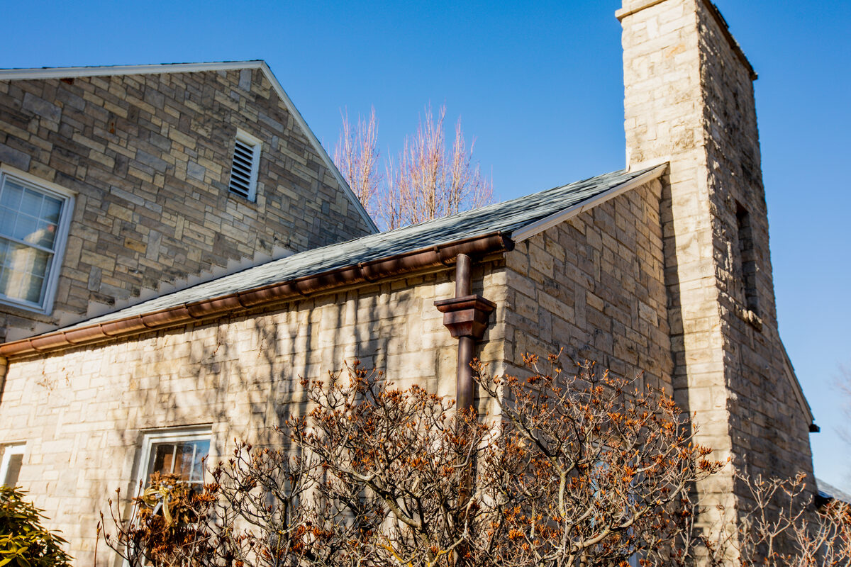 DaVinci synthetic slate roofing on a stone-faced home