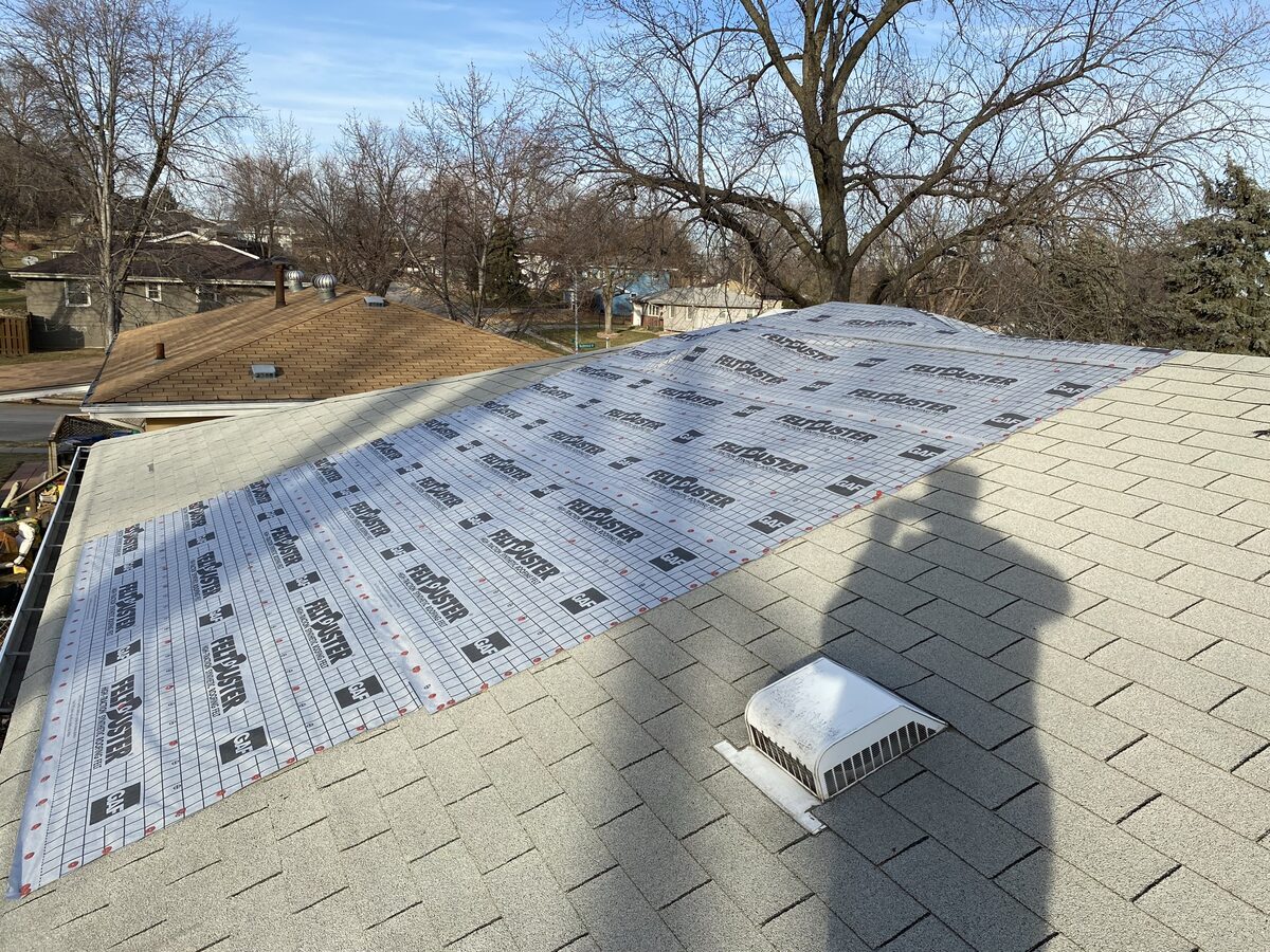 GAF FeltBuster synthetic underlayment being installed on residential roof