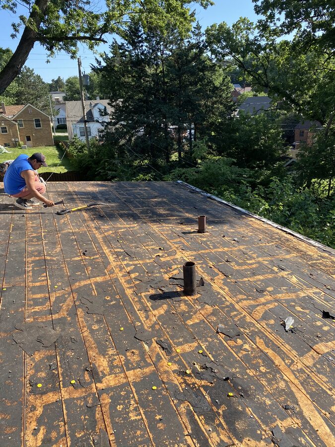 Roof tear-off exposing bare decking during Omaha roof replacement