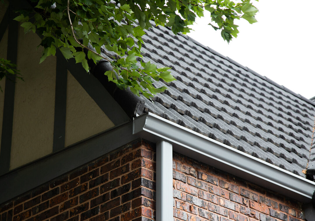 Unified Steel stone-coated roofing at eave with seamless gutter