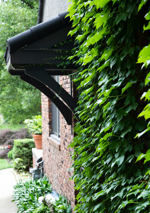 Custom black gutter bracket on Unified Steel metal roof installation